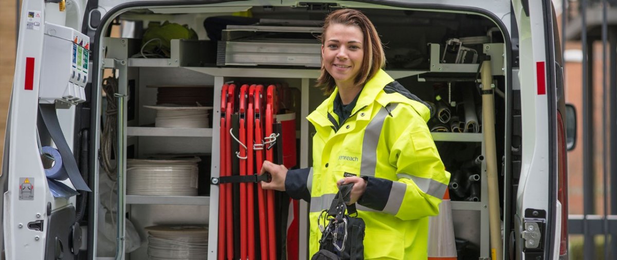 Women smiling near network cables